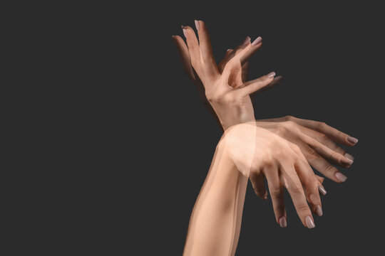 Stroboscopic photo of moving female hand on dark background