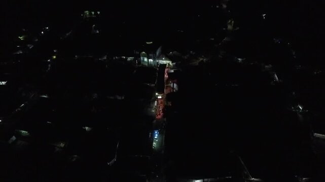 4K Aerial View of a Vibrant Indonesian Village Community Gathering at Night.