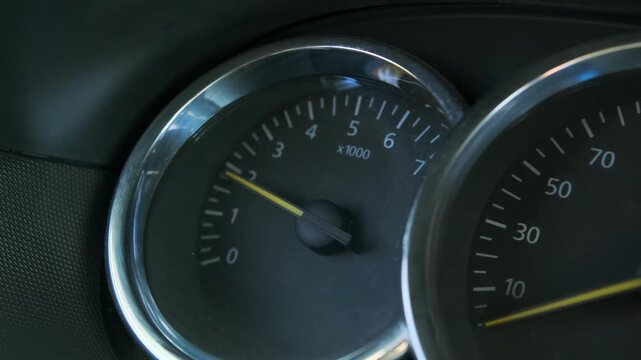 car engine revving close-up dashboard shot showing tachometer needle rising inside vehicle, driving action for transport, automotive performance and dynamic motion with speed and power