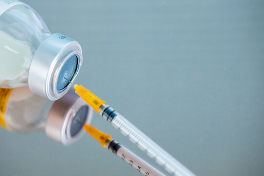 syringe and empty vial on clinical surface, end life decision, ethical dilemma euthanasia, assisted dying, vaccination sterile equipment, clinical sterile environment, control over life and death
