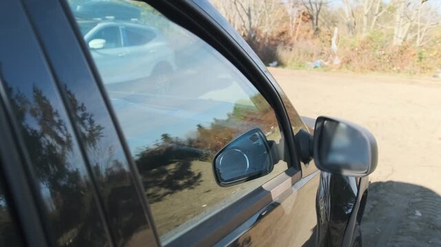 Car side window opening, closing with electric drive from outside view, smooth glass movement in SUV door, modern comfort feature, automotive mechanism in action, usability, everyday vehicle control