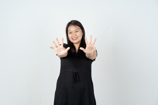 Young Asian woman holding up nine fingers for number sign counting