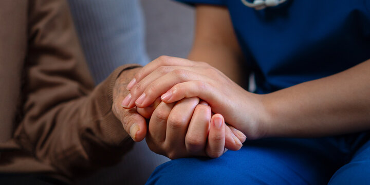 With empathetic and caring attention, professional nurses hold the hands of elderly patients to comfort and encourage them, while also offering advice on healthcare.