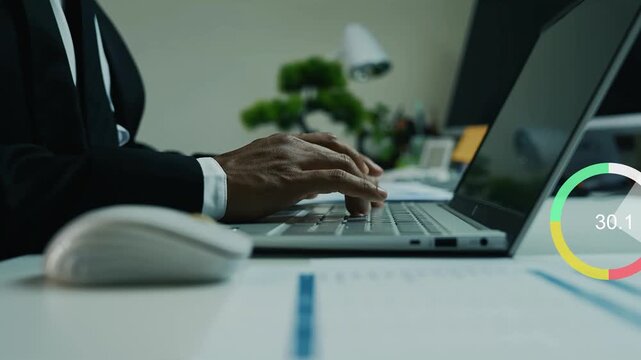businessman working on laptop computer with holographic business graph charts animation