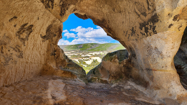 A window in the the D&ouml;ğer Asar Castle is a natural rock citadel used by Phrygians and Byzantines for defense. It features rock-cut rooms, silos, and cisterns. Known as a filming location for the movie