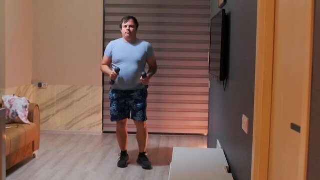 Man stepping into wide sumo stance with dumbbells at home, performing squat exercise, strength training for legs and hips, fitness workout indoors, bodybuilding routine and healthy lifestyle