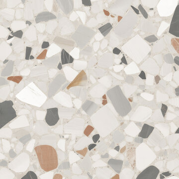 Terrazzo slab showcases large angular stone pieces in earthy tones integrated into a sleek white concrete background.