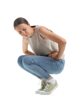 Young woman suffering from cystitis on white background