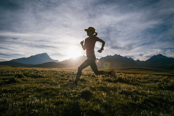 Fototapeta premium Trail runner running on the high altitude grassland mountain top