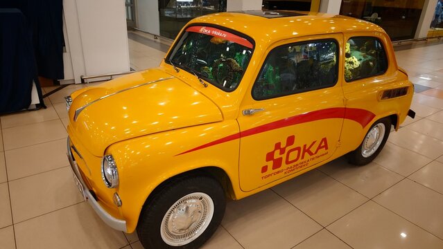 Kolpino, Russia - April 17, 2026: Vintage yellow car ZAZ 965, with Oka branding displayed indoors, showcasing classic design and retro style in a modern setting