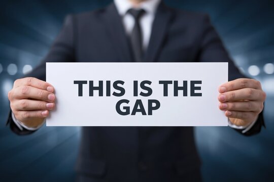 A Man in a Suit Identifying the Problem with a Sign This Is The Gap