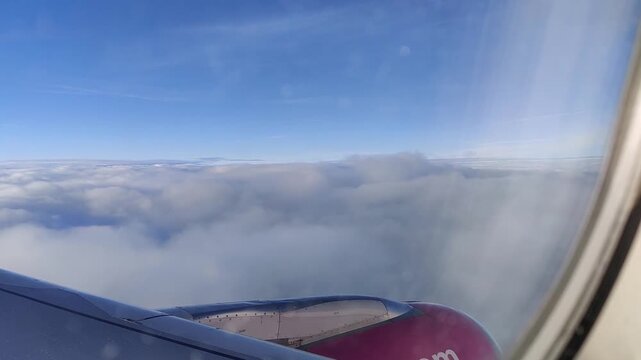 A view from an airplane window of white clouds
