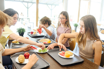 Students sharing a meal together in a lively school cafeteria environment