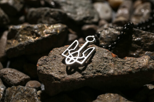 Chain with Ukrainian coat of arms on stones, closeup