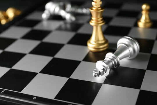 Chess pieces on board, closeup. Loser concept