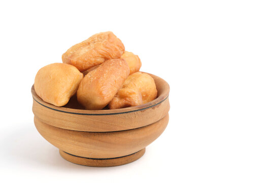 Central Asian fried dough bread called Baursak served in handcrafted wooden bowl.