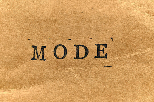 MODE written in bold, antique typewriter font on rustic, fiber textured paper background.