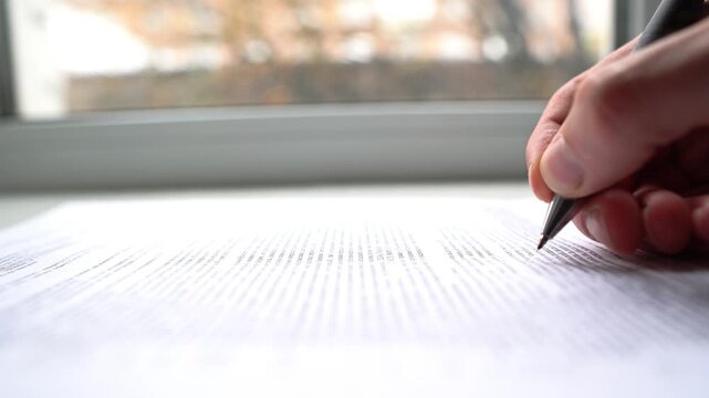 An office worker works with documents, writes documents