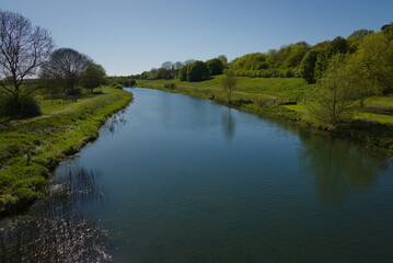 Ferry Meadows Country Park, Peterborough, England, UK - April 23 2026: Landscape shot of the River Nene from the Nene Park bridge on a late spring afternoon
