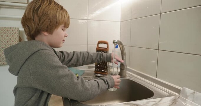 Kid Boy Drinks Glass of Water in Kitchen. 4K 10-bit