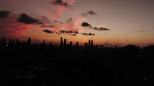 Jakarta, Indonesia &ndash; April 26th 2026: Aerial Cityscape Skyline Silhouette at Dramatic Pink and Orange Sunset. Urban Metropolitan Landscape with High-Rise Buildings