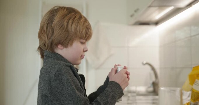 Kid Boy Drinks Glass of Water in Kitchen. 4K 10-bit