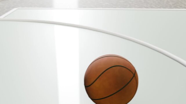Tilting camera revealing basketball spinning, bouncing and settling on gym court near white arc
