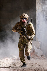 Obraz premium Armed Soldier Running Through Urban Ruins Wearing Tactical Camouflage Gear With Rifle