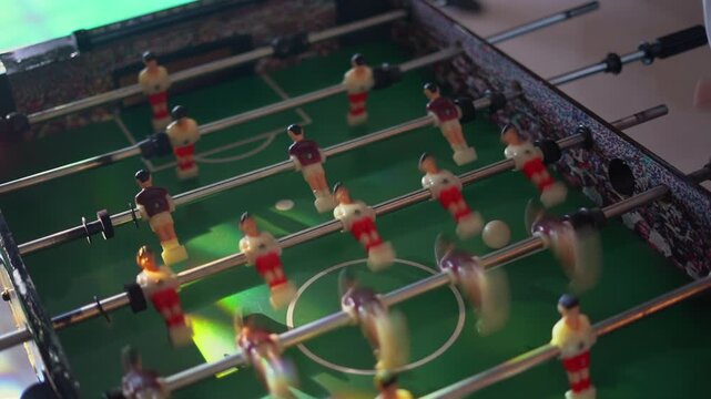 Children playing table soccer at a party