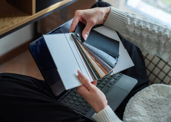Person choosing material samples for interior design project © Olena Rudo