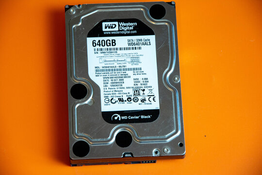 Sosnovy Bor, Russia - September 02, 2025: Western Digital 640GB hard drive with SATA interface and detailed specifications on a bright orange background