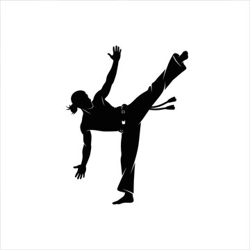 Silhouette of a person performing a capoeira kick in mid-air.