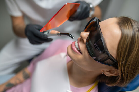Close up of woman in protective glasses during UV polymerization