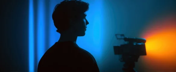 A videographer dances in a neon-lit studio like a firefly in twilight. © ckybe