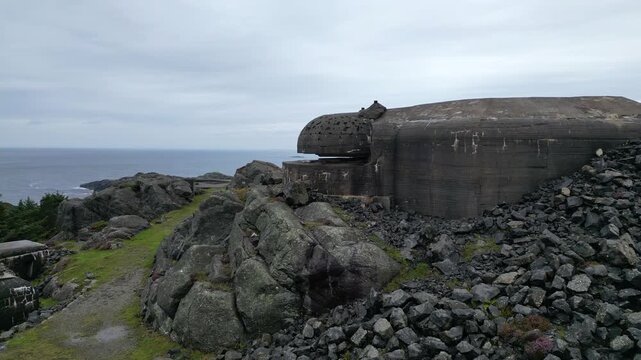 Close Fly-By of a Bunker on Top of Hill Next To The Sea 4k drone