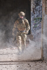Obraz premium Armed Soldier In Tactical Gear Walking Through Dusty Urban Ruins During Military Operation