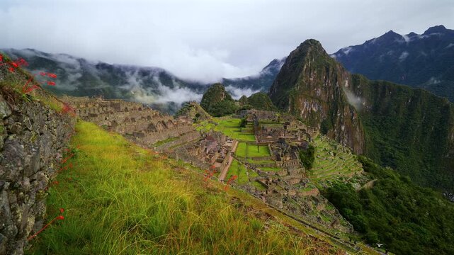 Machu Picchu terrace layers Peru's Inca Temple early morning landscape clouds fog layer Orchid flowers Huayna Picchu Mountain Inca Trail Circuit Aguas Calientes Peruvian Andres Mountains sanctuary pan