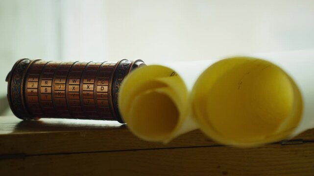 Pull focus reveals a cryptex beside parchment scrolls, building intrigue as if a hidden message is about to be uncovered, suited for mystery storytelling or escape room content.