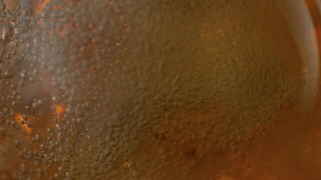 Super Slow Motion Shot of Rippling Fresh Beer With Bubbles at 1000fps.