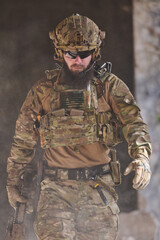 Tactical Soldier in Full Multicam Gear With Helmet, Plate Carrier and Assault Rifle Walking Through Dust © .shock
