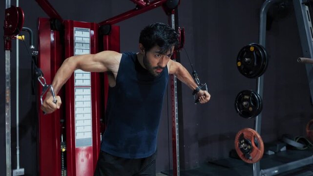 Athletic Man Performing Cable Chest Fly in Gym. Male Athlete Training Chest Muscles with Cable Machine, bodybuilding, upper body training and muscle development in Gym.