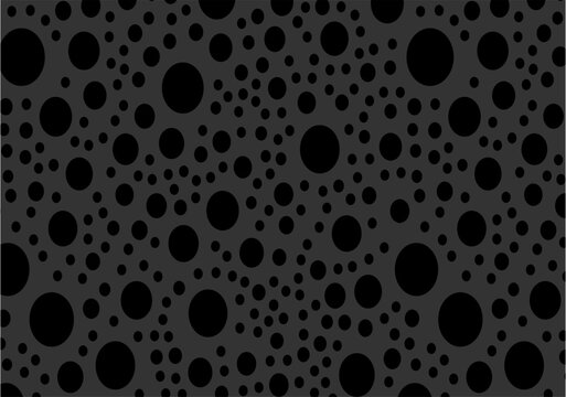 An abstract pattern featuring black circles of various sizes scattered across a dark charcoal grey background, creating a textured, polka-dot aesthetic with a modern, minimalist feel.