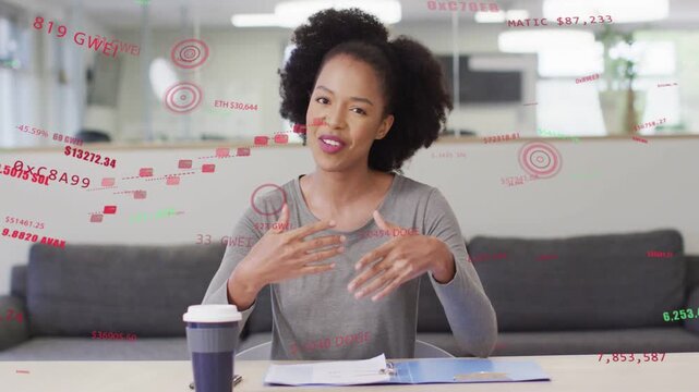 Woman presenting at office table, gesturing and causing animated crypto tickers, explaining market