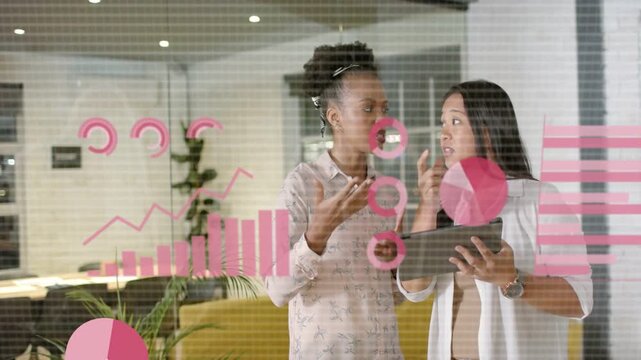 Two women gesturing and scanning tablet in office, activating AR charts and analysing business data