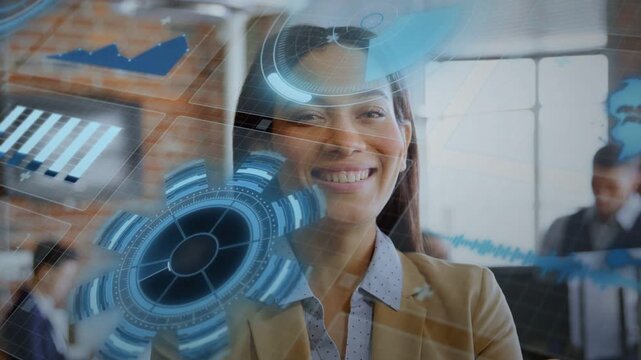 Woman watching in open office holo charts globe appearing left, rotating, causing smile for tech