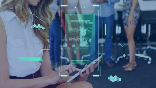 Seated woman tapping tablet in tech office, holographic UI animating over tablet and updating data