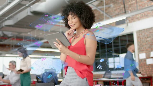 Woman standing in open office scrolling tablet and generating holographic UI for technology review