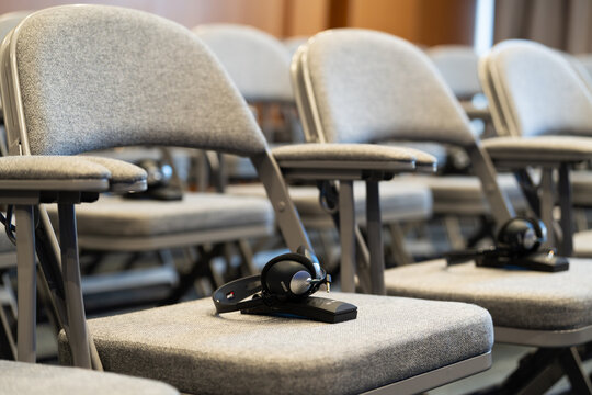 Dubrovnik Croatia 28 April 2026.Modern press conference room equipped with professional simultaneous interpretation system, featuring multiple Bosch interpretation headsets neatly arranged on tables. 