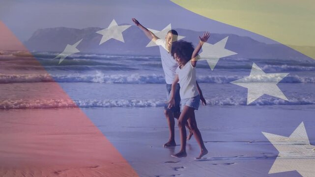 Girl raising arm and dad mirroring, playing on shore, ad flag overlay over subjects leaving prints