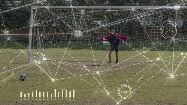 Soccer player in red kit placing ball running striking aiming goal while keeper diving HUD overlay